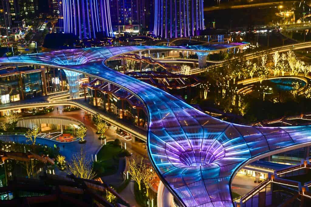 Futuristic city with illuminated walkways and vibrant lights, showcasing modern urban development an.